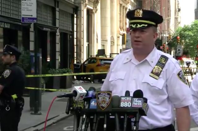 An NYPD officials briefs the media on the cab crash.
